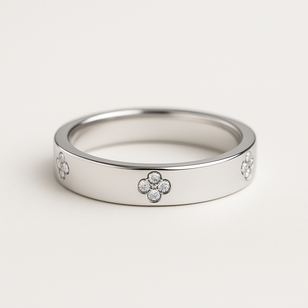 Silver band with moissanite clover motif design on a light gray background