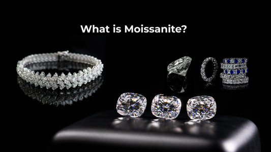 Moissanite and diamond jewelry scattered on a dark reflective surface