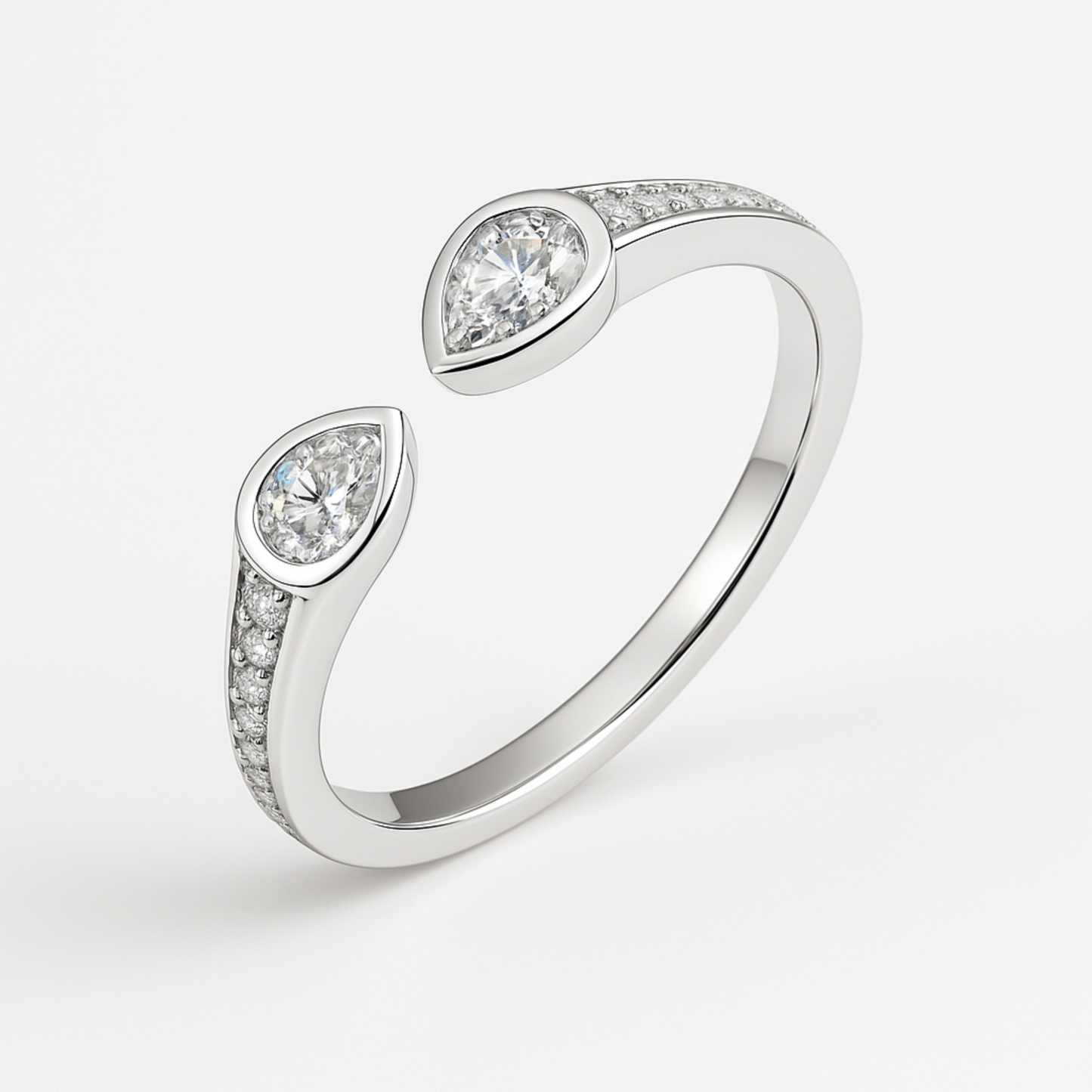 Elegant open-band silver ring with two opposing pear-shaped moissanite stones in bezel settings and pavé-set stones along the shoulders.