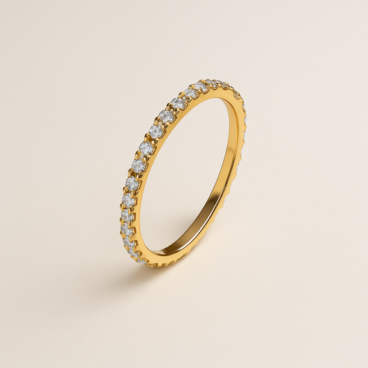 Zedarii eternity gold ring with moissanite on a beige background
