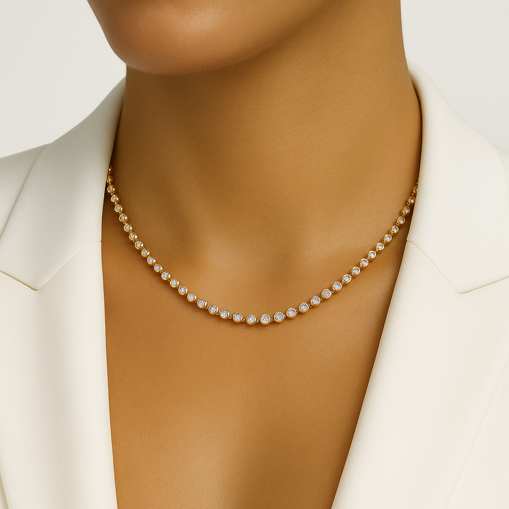 Gold bezel tennis necklace on a model with a white background