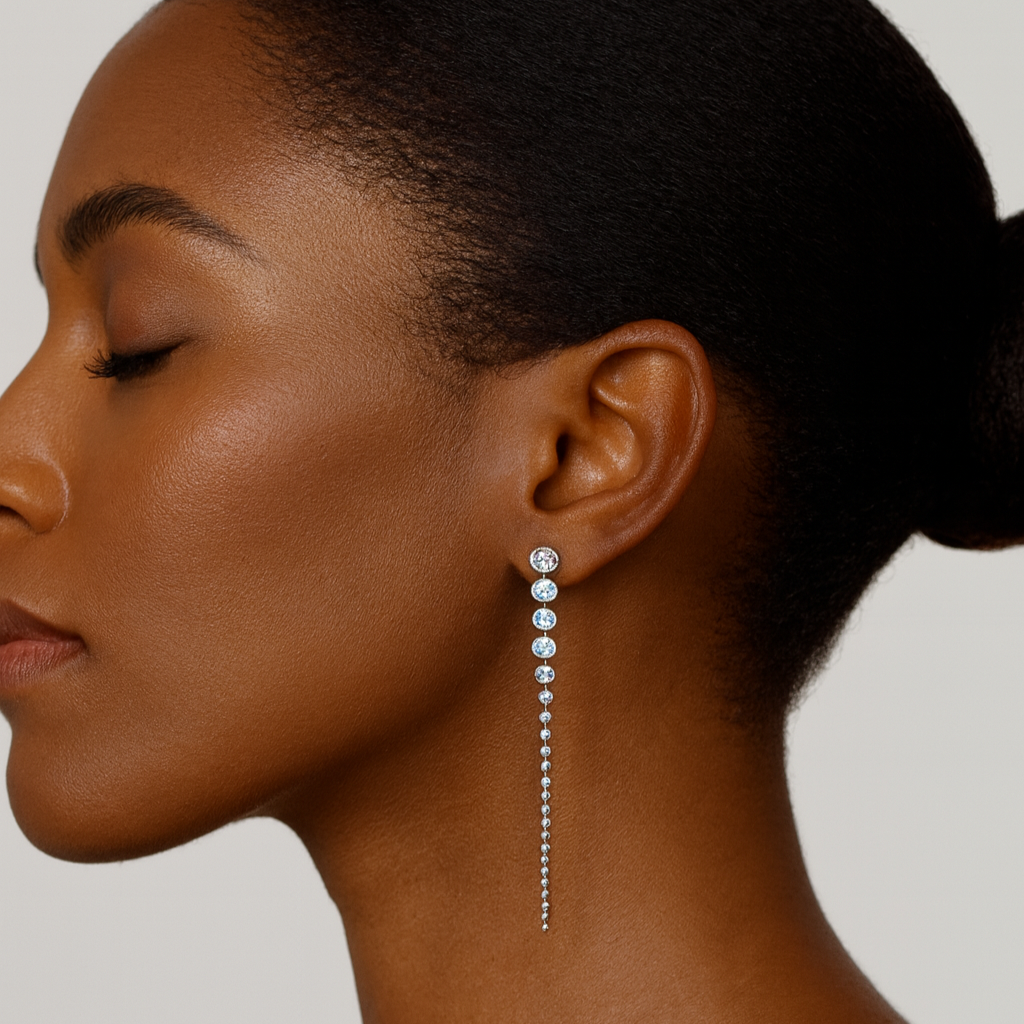 Woman wearing a zedarii bezel-set dangling earring with a neutral background