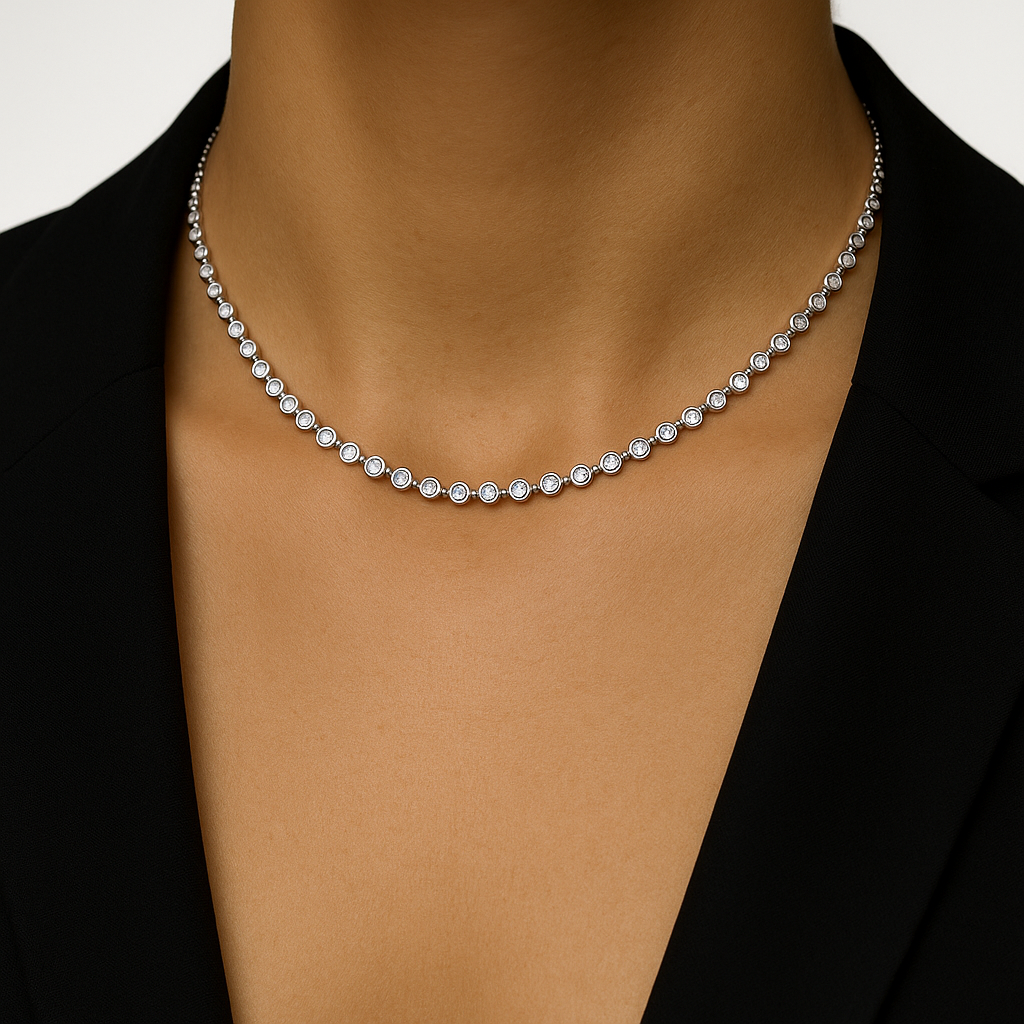 Silver  bezel tennis necklace on a model against a neutral background